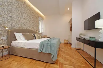 a bedroom with a bed and a desk with a television at YCH-Casa Bella- Luxury home near Piazza Venezia in Rome