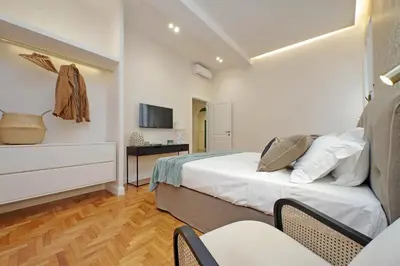 a bedroom with a bed and a table with chairs at YCH-Casa Bella- Luxury home near Piazza Venezia in Rome