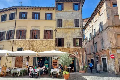 a group of people sitting at tables in front of a building at YCH-Casa Bella- Luxury home near Piazza Venezia in Rome