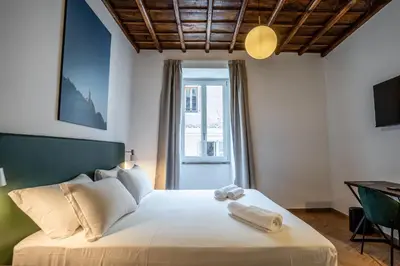 a bedroom with a bed with two towels on it at Fantini Rooms-Monti in Rome