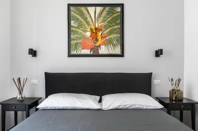 a bedroom with a bed with two nightstands and a picture at Allegra Domus in Rome