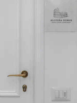 a white door with a sign on it at Allegra Domus in Rome