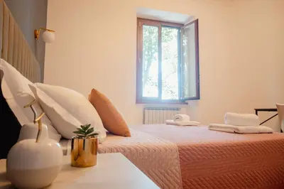 a bedroom with a large bed with a window at Maison Vaticano in Rome