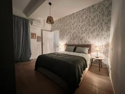 a bedroom with a bed with a patterned wall at Antinori Stresa Home in Rome