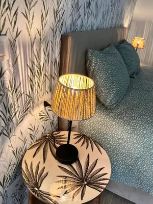 a lamp on a table next to a bed at Antinori Stresa Home in Rome