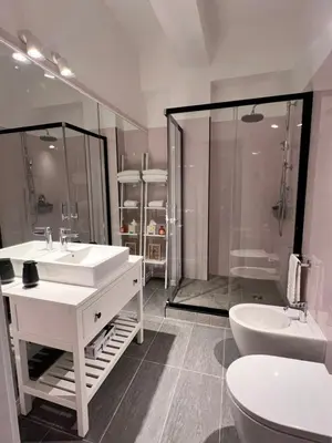 a bathroom with two sinks and a shower and a toilet at Antinori Stresa Home in Rome