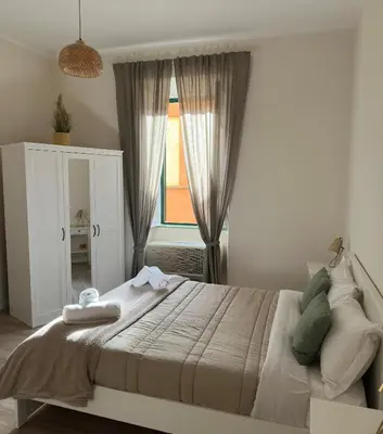 a bedroom with a large bed and a window at Colosseo House in Rome