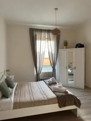 a bedroom with a large bed with a window at Colosseo House in Rome