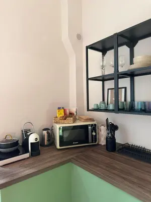 a microwave sitting on a counter in a kitchen at Colosseo House in Rome