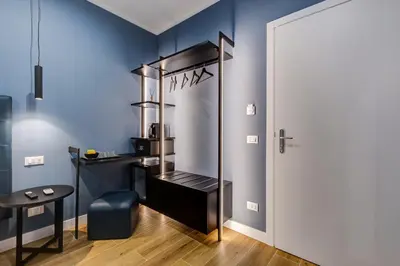 a dressing room with a blue accent wall at LISA SUITE in Rome