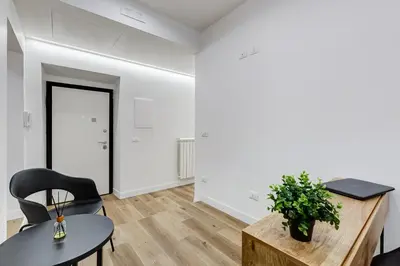 a room with a table and chairs and a door at LISA SUITE in Rome