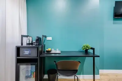 a desk with a chair next to a blue wall at LISA SUITE in Rome
