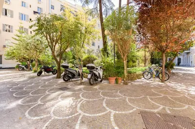a group of motorcycles parked next to trees and buildings at LISA SUITE in Rome