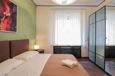 a bedroom with a large bed and a window at Parioli Suites Apartments in Rome