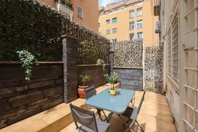 a small patio with a table and chairs on a balcony at Parioli Suites Apartments in Rome