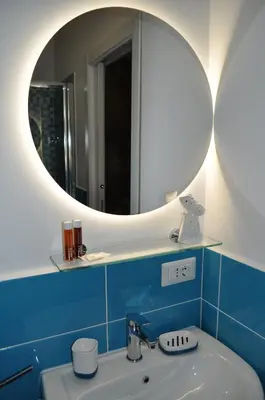 a bathroom with a sink and a mirror at A casa di Emi e Giò in Rome
