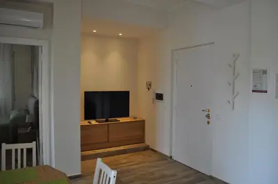 a living room with a flat screen tv on a dresser at A casa di Emi e Giò in Rome