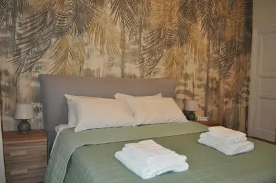a bedroom with a bed with towels on it at A casa di Emi e Giò in Rome