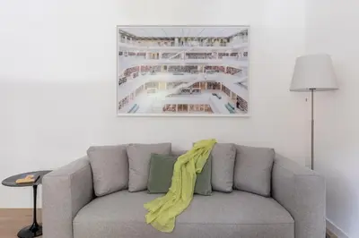 a couch with a yellow blanket on it in a living room at iFlat Vatican 2 Bedroom Design Apartment in Rome