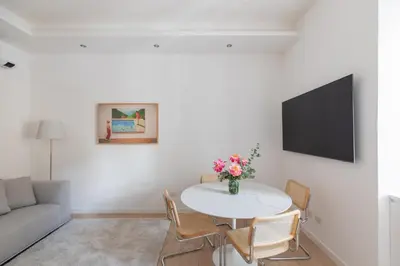 a living room with a table and a couch at iFlat Vatican 2 Bedroom Design Apartment in Rome