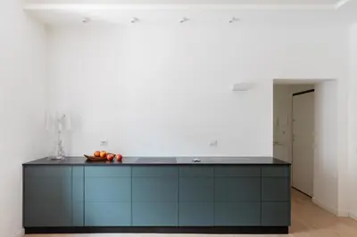 a kitchen with a blue island in a room at iFlat Vatican 2 Bedroom Design Apartment in Rome