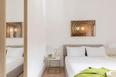 a bedroom with two beds and a mirror at iFlat Vatican 2 Bedroom Design Apartment in Rome