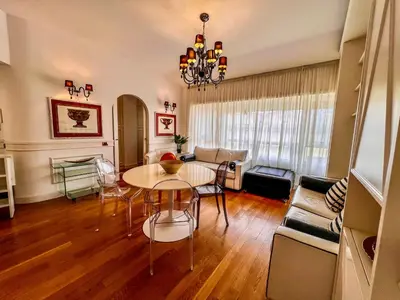 a living room with a table and a couch at Qg Tacito 90 in Rome