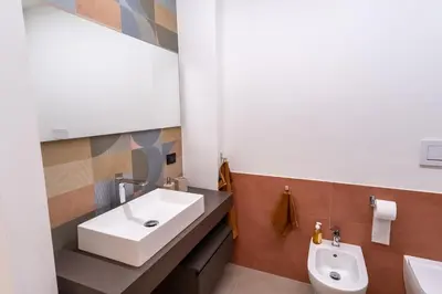 a bathroom with a sink and a toilet at Living Testaccio - Modern Apartment in Rome