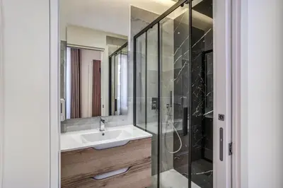 a bathroom with a sink and a glass shower at Vatican Eagle in Rome