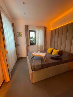 a bedroom with a large bed with a table on it at JOIVY Exclusive 2-Bedroom Villa with Private Garden - 5 minutes from the Colosseum in Rome