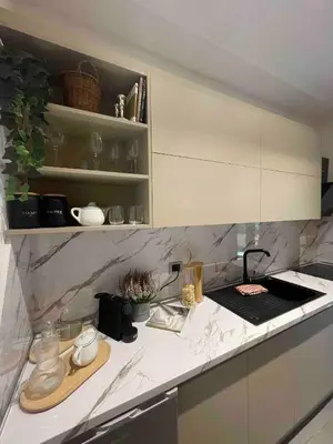 a kitchen with white marble counter tops and a counter top at JOIVY Exclusive 2-Bedroom Villa with Private Garden - 5 minutes from the Colosseum in Rome