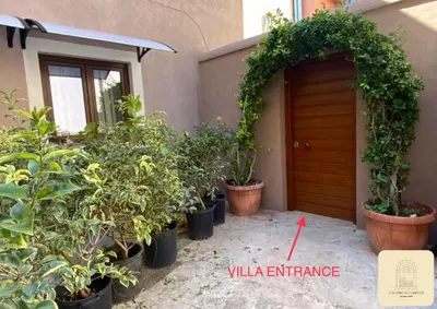 a bunch of potted plants in front of a house at JOIVY Exclusive 2-Bedroom Villa with Private Garden - 5 minutes from the Colosseum in Rome