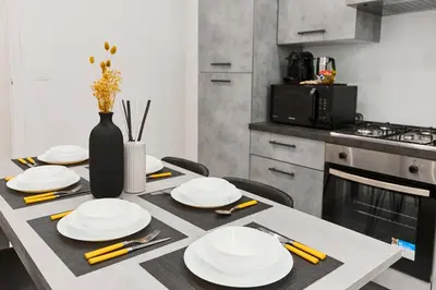 a kitchen with a table with plates and a vase at Labi Home Colossevm in Rome