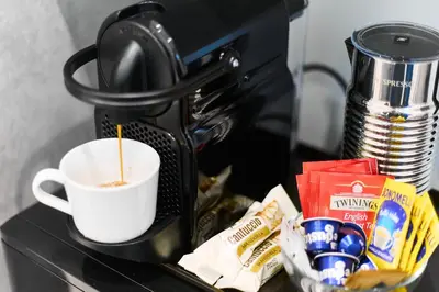 a coffee maker with a cup of coffee on a counter at Labi Home Colossevm in Rome