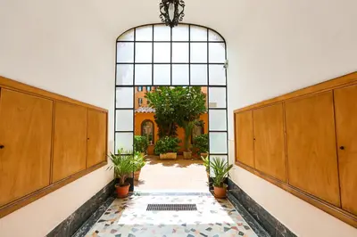 an empty hallway with potted plants in a building at Labi Home Colossevm in Rome