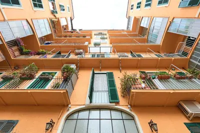 an orange building with stairs and plants on it at Labi Home Colossevm in Rome