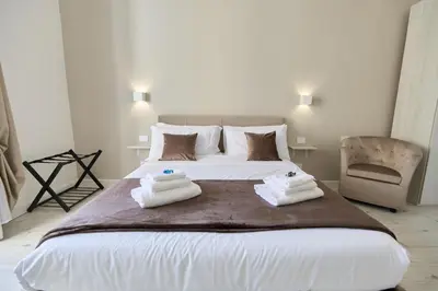 a bedroom with a large bed with towels on it at Labi Home Colossevm in Rome