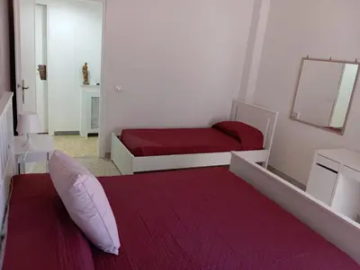 a bedroom with two beds and a red blanket at A & F Apartment in Rome