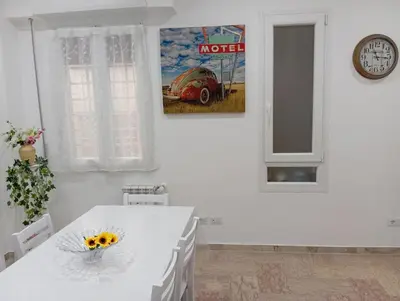a dining room with a table and a clock at A & F Apartment in Rome