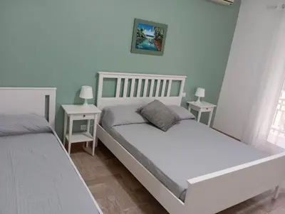 a bedroom with two beds and two night stands at A & F Apartment in Rome