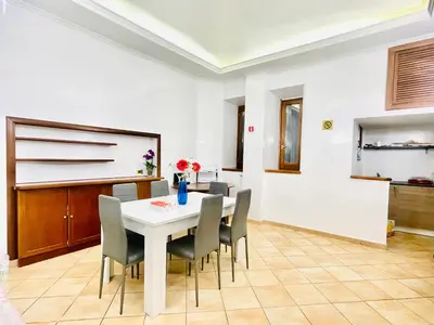 a dining room with a white table and chairs at Hotel Rome place in Rome