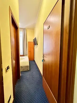 a hallway with a door to a room with a bed at Hotel Rome place in Rome