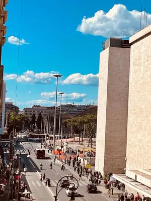 a group of people walking around a city street at Hotel Rome place in Rome