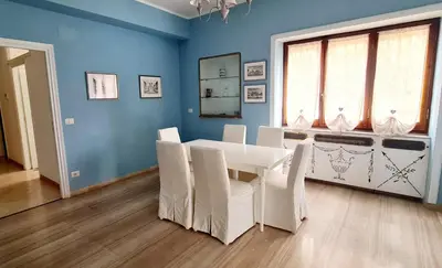 a dining room with a white table and white chairs at Exclusive 230m2 Apt with Terrace and Panoramic Balcony in Rome