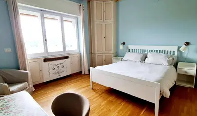 a bedroom with a white bed and a window at Exclusive 230m2 Apt with Terrace and Panoramic Balcony in Rome
