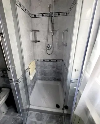 a shower with a glass door in a bathroom at Exclusive 230m2 Apt with Terrace and Panoramic Balcony in Rome