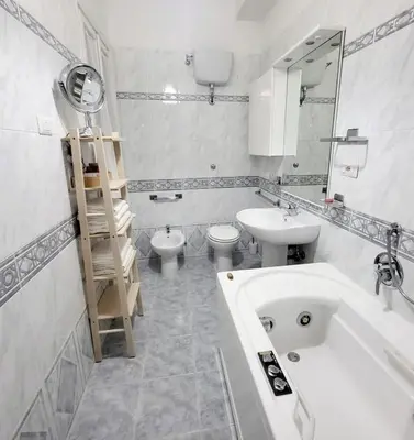 a bathroom with a sink and a tub and a toilet at Exclusive 230m2 Apt with Terrace and Panoramic Balcony in Rome