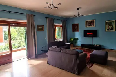 a living room with a couch and a tv at Exclusive 230m2 Apt with Terrace and Panoramic Balcony in Rome
