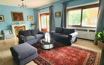 a living room with two couches and a rug at Exclusive 230m2 Apt with Terrace and Panoramic Balcony in Rome