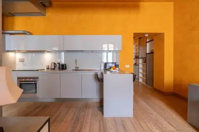 a kitchen with white cabinets and a counter top at Elegant Diocleziano Suite in Rome